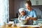 Happy family in kitchen. mother and child preparing dough, bake