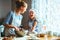 Happy family in kitchen. mother and child preparing dough, bake