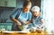 Happy family in kitchen. mother and child preparing dough, bake