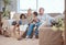 Happy, family and laptop on the sofa with children and grandparents on home sofa. Senior man and woman relax online with