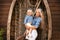 Happy family lifestyle concept. Family look. Portrait of Blonde Mother holding her daughter hugging by boat with fishing net.