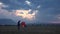 Happy Family Lifting Chinese Lantern on Sky Playing Outdoor at Sunset, Mountains