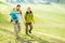 Happy family with little child doing trekking on switzerland mountain in summer time - Young people having fun in landscape nature