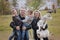 Happy family with little kids and husky dog in the park, autumn outdoors