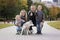 Happy family with little kids and husky dog in the park, autumn outdoors