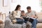 Happy family with little son reading books. Winter vacation