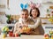 Happy family loving grandfather and cute little girl granddaughter embracing while painting Easter eggs