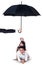 Happy family lying in studio under umbrella