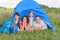 Happy family lying in tent