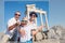 Happy family making a selfie photo using a samrtphone and Selfie stick on summer vacation in Turkey, Side, Manavgat with Temple of