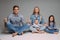 happy family meditate together in the studio