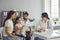 Happy family in modern pediatrician`s office consulting friendly young female doctor