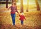 Happy family mother and child little daughter on autumn walk