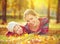 Happy family: mother and child little daughter playing and laughing in autumn