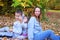 Happy family mother with children son and daughter walks in nature in autumn park, happy childhood. Happy family having