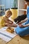 Happy family mother, daughter and cat spending time together playing Maria Montessori materials