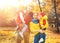 Happy family mother, father and children on an autumn walk