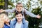 Happy family mother, father and his pupil son playing outdoor in park.