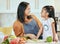 Happy family, mother girl cooking food for a healthy vegan diet with spaghetti and vegetables at home. Smile