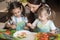 Happy family mother and kids are preparing healthy food, they improvise together in the kitchen