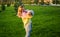 Happy family. Mother playing with her daughter on green lawn with grass