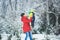 a happy family. mother and three children playing in the winter forest