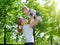 Happy family. Mother throws up baby on the nature