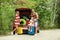 Happy family near car trunk with suitcases outdoors