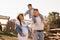 Happy family near horses at a farmer& x27;s ranch at sunset