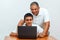 Happy family old grandfather and grandson on laptop.Elderly teacher trainer and teen pupil boy.