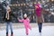 Happy family at outdoor skating rink in winter