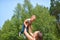 Happy family outdoors. mother throws baby up, laughing and playing in summer on the nature