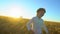 Happy family outdoors walking together on wheat field with smiling boy. son kid child running from parents mother