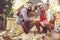 Happy family outside in colorful fall backyard poses to camera.