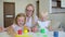 Happy family paints colors. Happy little childs making colorful color handsprint on the white paper. A little cute happy