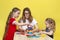 A happy family palying a round of jenga with their lovely daughters. Mother and dauters have fun playing tower game