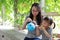 Happy family parental child time mother love children daughter play with baby girl blew balloon together have fun in summer park