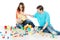 Happy family. Parents playing toys blocks with child