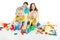 Happy family. Parents with two kids playing toys blocks