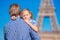 Happy family in Paris background Eiffel Tower. Dad and little girl on french vacation.