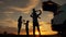 Happy family in the park. Silhouette of a happy family in the park at sunset. Parents play with their children at sunset