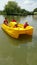 Happy family in pedalo boat on small lake