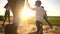 happy family. people in the park. children child running together in the park on the sand silhouette. daughter and son