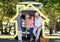 Happy family with pet dog overlaid with house enjoying picnic