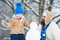 Happy family plaing with a snowman on a snowy winter walk. Best winter game for happy family. Winter father and son