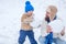 Happy family plaing with a snowman on a snowy winter walk. Father and son making snowball on winter white background.