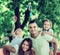 Happy family playing colorful windmills