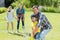 Happy family playing cricket together