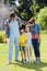 Happy family playing cricket together in backyard