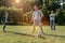 Happy family playing football outdoors